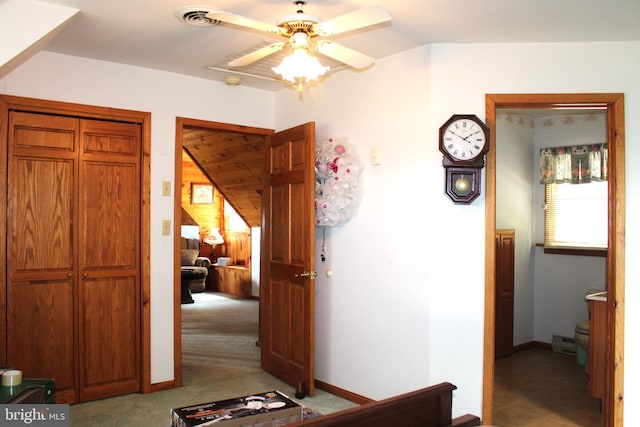 corridor featuring light carpet and a baseboard heating unit