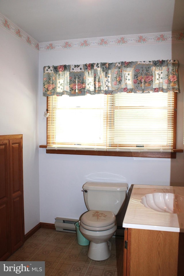 bathroom featuring vanity, a baseboard radiator, and toilet