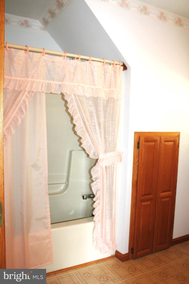 bathroom with shower / bath combo with shower curtain