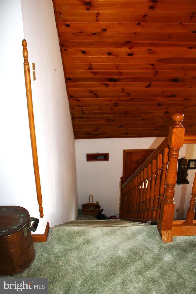 staircase with lofted ceiling, wooden ceiling, and carpet floors