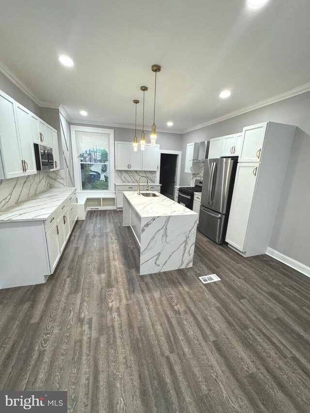 kitchen featuring an island with sink, white cabinets, dark hardwood / wood-style floors, and stainless steel appliances