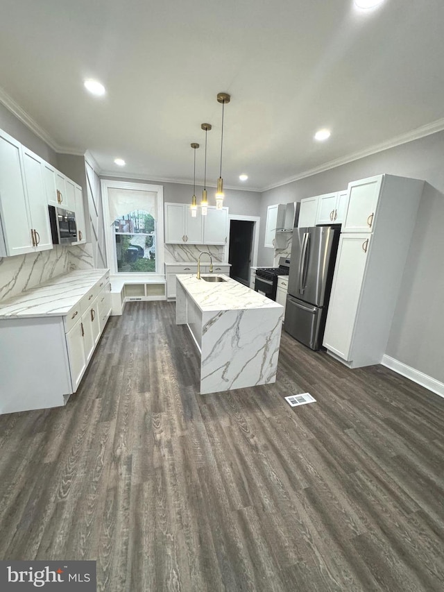 kitchen with pendant lighting, crown molding, stainless steel appliances, and white cabinets