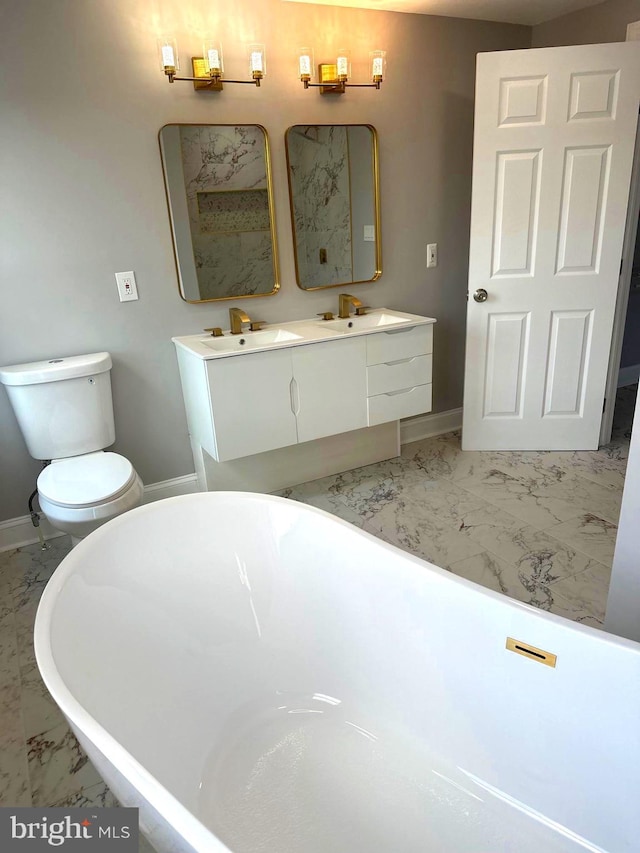 bathroom with vanity, a bath, and toilet