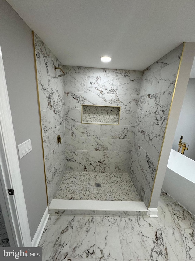 bathroom with tiled shower