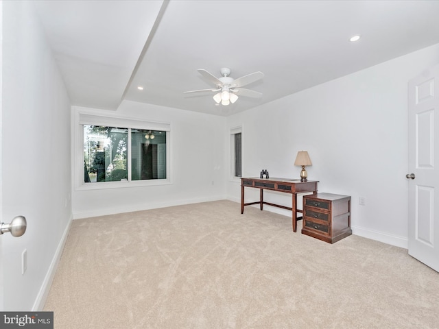 interior space with ceiling fan and light colored carpet