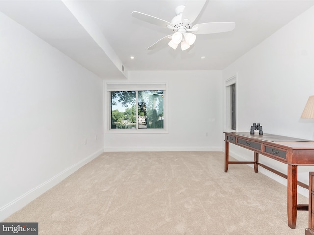 carpeted office space featuring ceiling fan