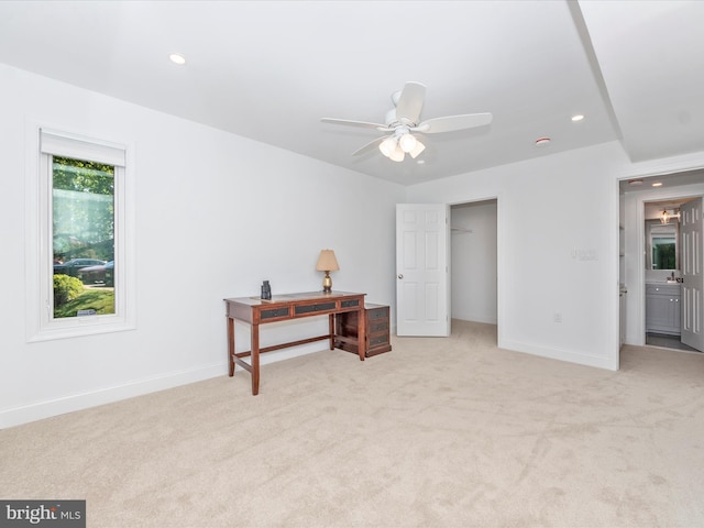 bedroom with light carpet, connected bathroom, a closet, and ceiling fan