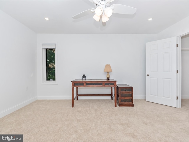 interior space with ceiling fan and light colored carpet