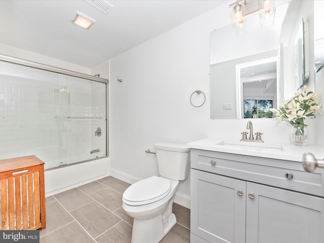 full bathroom featuring tile patterned flooring, vanity, toilet, and enclosed tub / shower combo