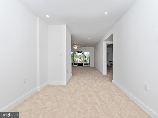 hallway featuring light carpet