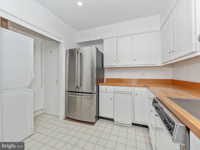 kitchen with white cabinets, stainless steel fridge, white dishwasher, and wooden counters