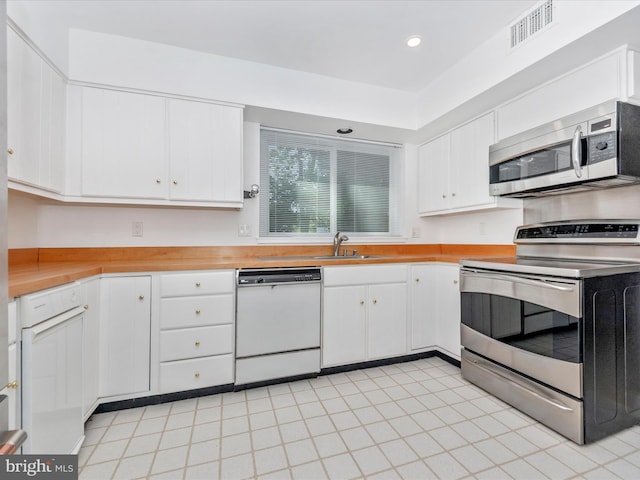 kitchen featuring white cabinets, sink, and stainless steel appliances