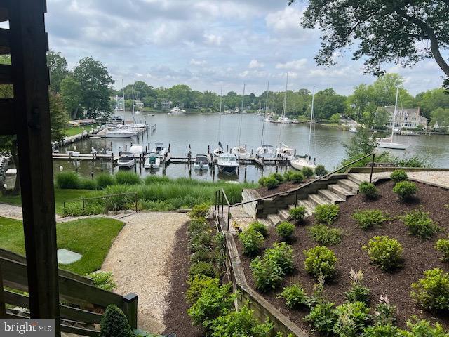 dock area featuring a yard and a water view