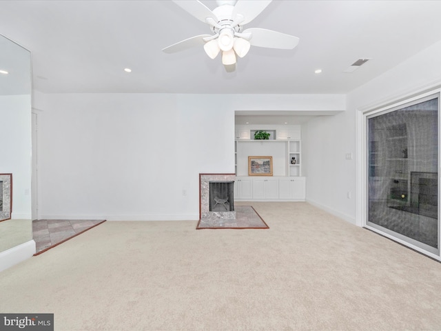 unfurnished living room with ceiling fan and light colored carpet