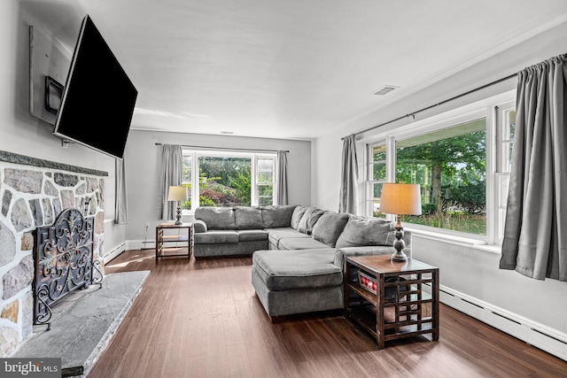 living room featuring a fireplace, dark hardwood / wood-style flooring, and baseboard heating