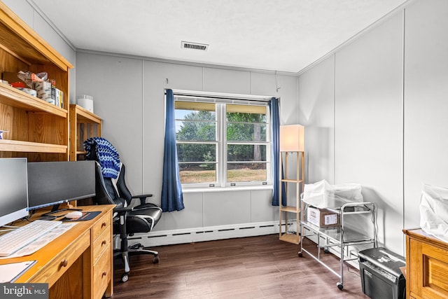 office with dark hardwood / wood-style floors, baseboard heating, and crown molding