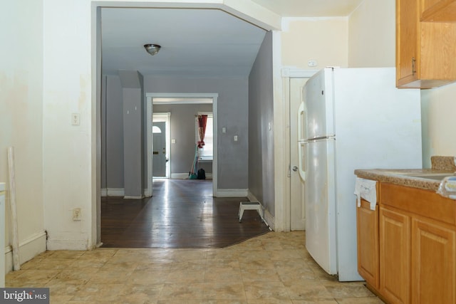 kitchen featuring white refrigerator, sink, and light hardwood / wood-style flooring