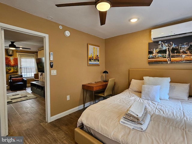 bedroom with ceiling fan, an AC wall unit, and dark hardwood / wood-style floors