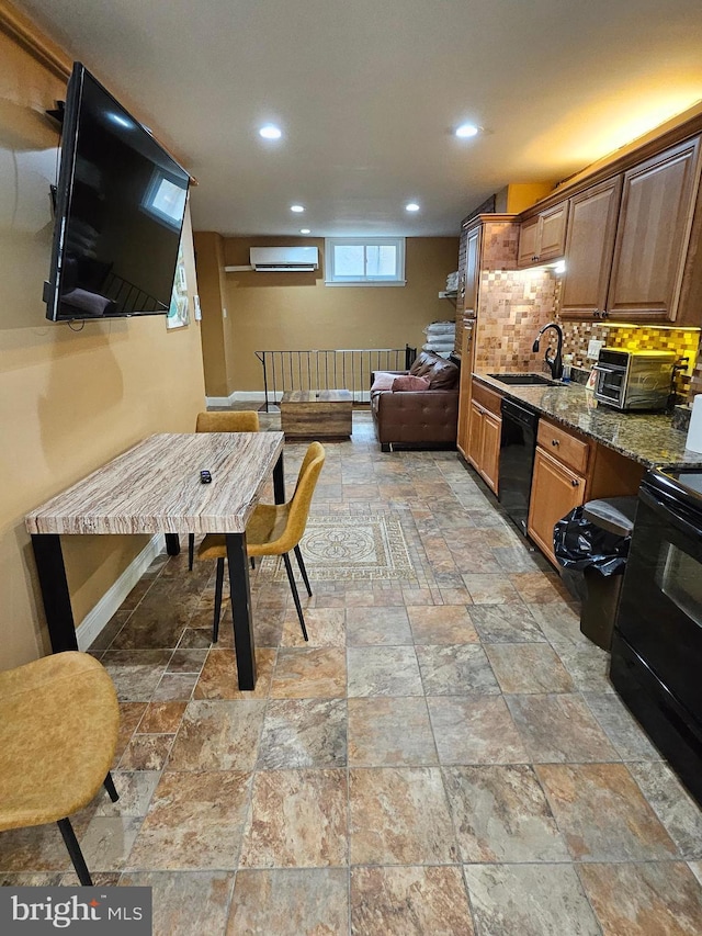 kitchen with tasteful backsplash, sink, dark stone countertops, an AC wall unit, and black appliances