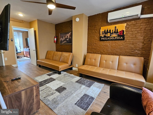 living room featuring a wall unit AC, ceiling fan, and wood-type flooring