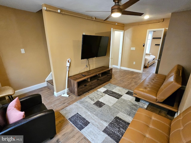 living room with ceiling fan and light hardwood / wood-style floors