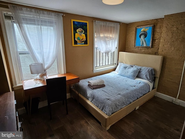 bedroom featuring multiple windows and dark hardwood / wood-style floors