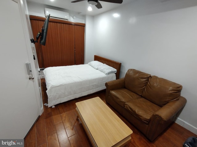 bedroom featuring ceiling fan, dark hardwood / wood-style floors, and a wall mounted air conditioner