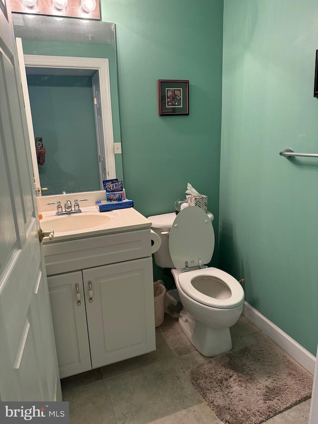 bathroom featuring toilet and vanity