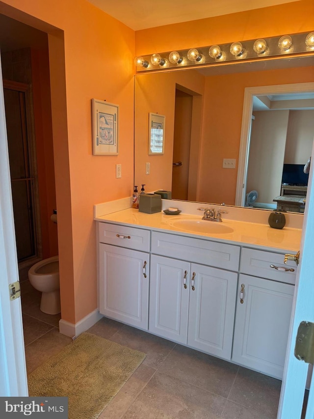 bathroom featuring walk in shower, vanity, and tile patterned flooring