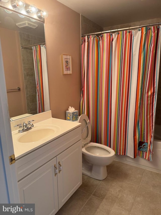 full bathroom featuring toilet, vanity, and shower / bathtub combination with curtain