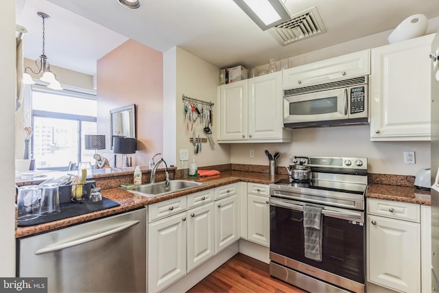 kitchen with white cabinets, stainless steel appliances, and sink