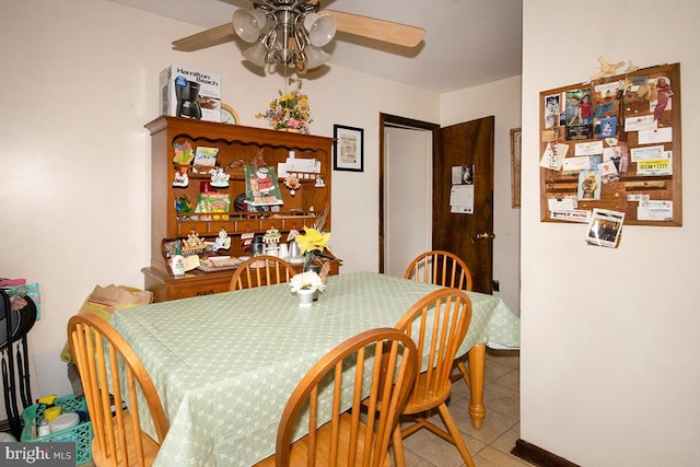 tiled dining space with ceiling fan