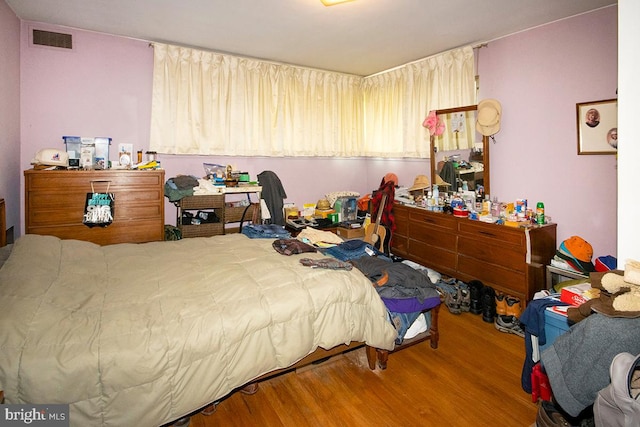 bedroom with hardwood / wood-style flooring