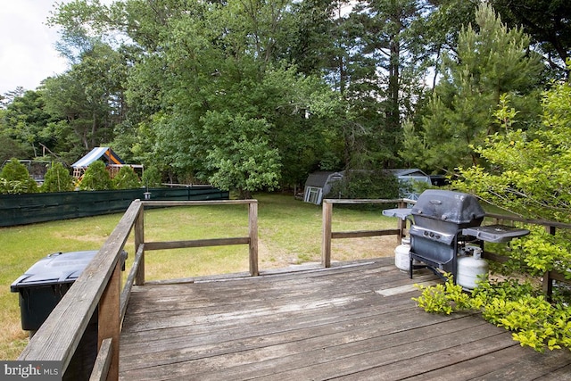 wooden terrace with area for grilling and a lawn