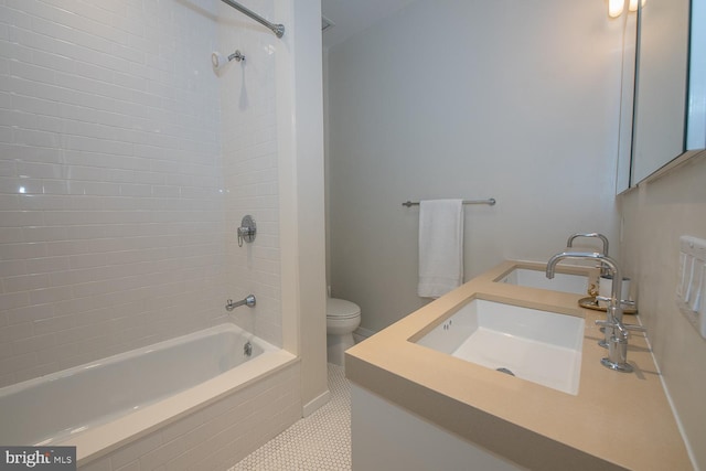 full bathroom with vanity, tile patterned flooring, tiled shower / bath combo, and toilet