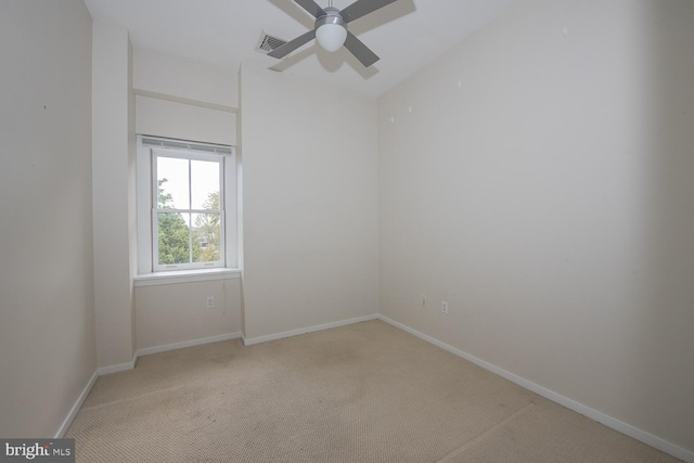 carpeted empty room featuring ceiling fan