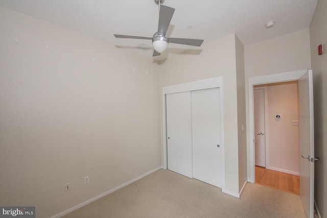 unfurnished bedroom with light colored carpet, a closet, and ceiling fan