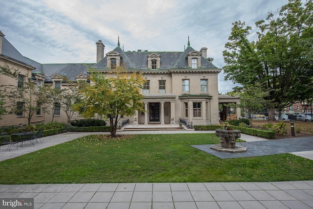 rear view of house with a yard