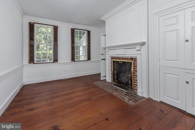 unfurnished living room with crown molding, dark hardwood / wood-style flooring, and a brick fireplace