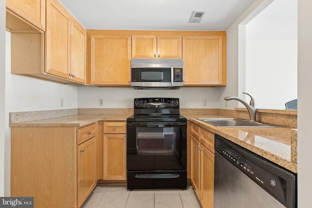 kitchen with light brown cabinets, sink, light tile patterned floors, light stone counters, and stainless steel appliances