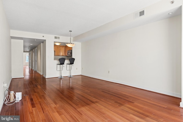 unfurnished living room featuring wood-type flooring