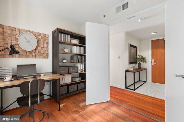 office area with light hardwood / wood-style floors