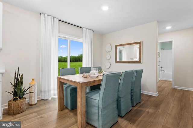 dining space with wood-type flooring