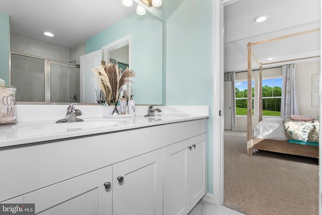 bathroom featuring vanity and a shower with door