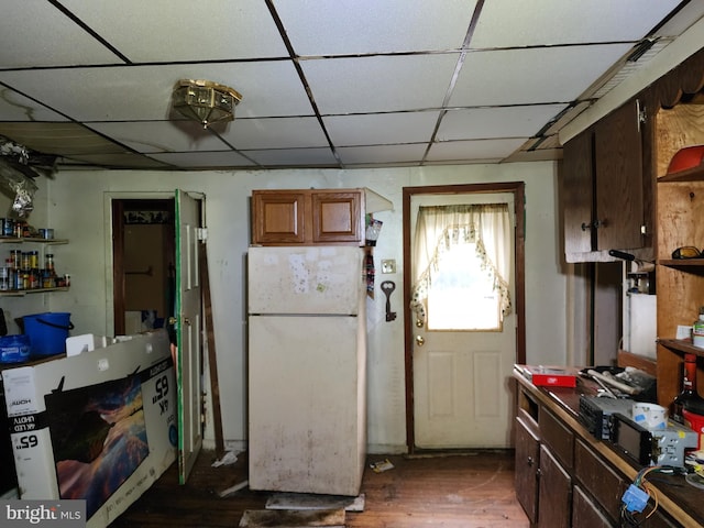 kitchen with white fridge and dark hardwood / wood-style flooring