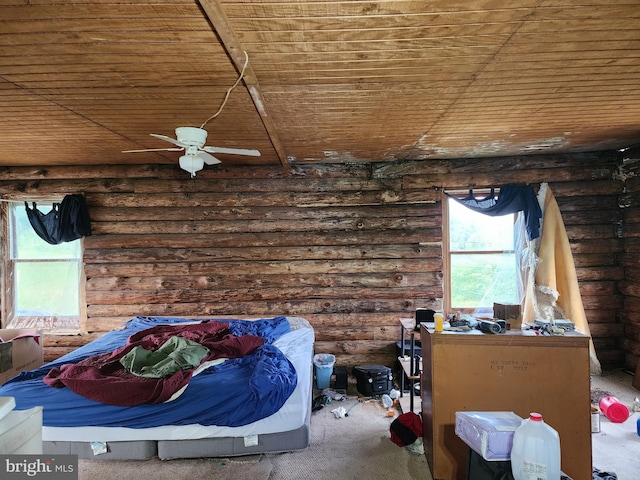 bedroom with ceiling fan, wooden ceiling, and rustic walls