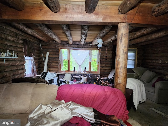 bedroom featuring beam ceiling and log walls