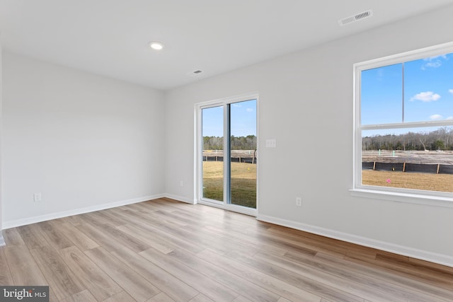 empty room with light hardwood / wood-style floors