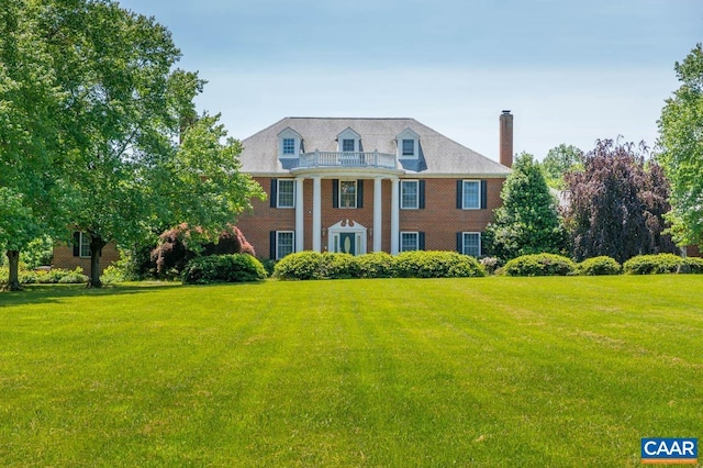 colonial-style house with a front yard