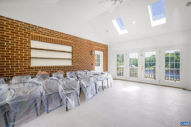 14186 Devils Three Jump Rd, Milford, VA 22514 - living room featuring a skylight, high vaulted ceiling, ceiling fan, and brick wall